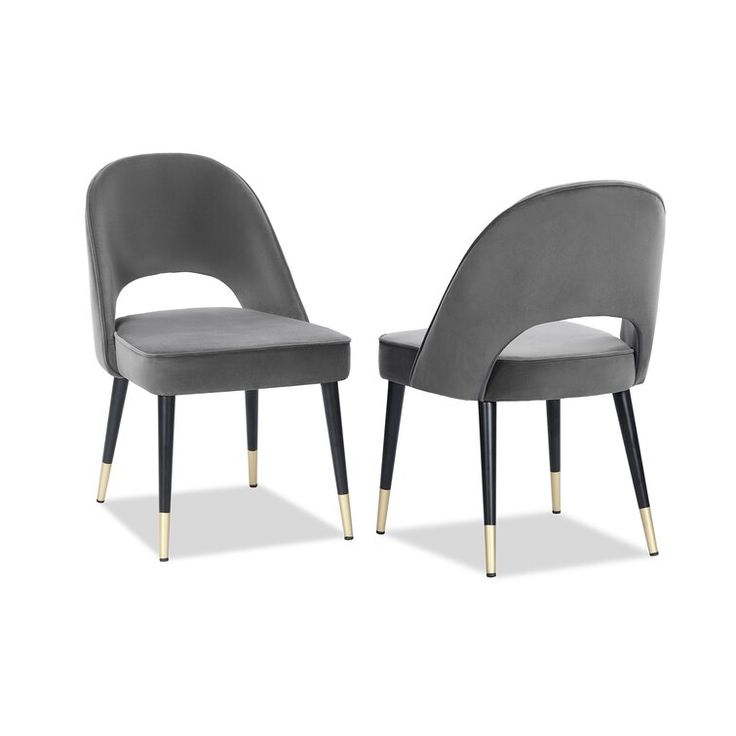 grey velvet dining chairs with cut-out back and black legs with gold tips