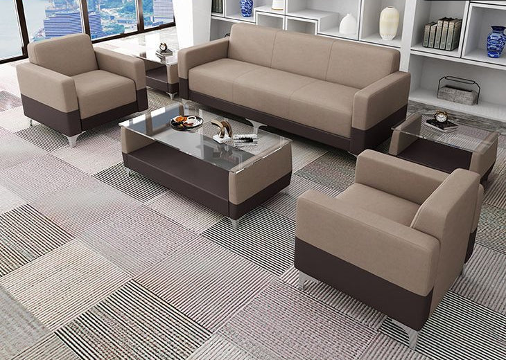Modern brown and beige office sofa set featuring a three-seater, two armchairs, and glass-top tables in a stylish corporate lounge setting with a city view.