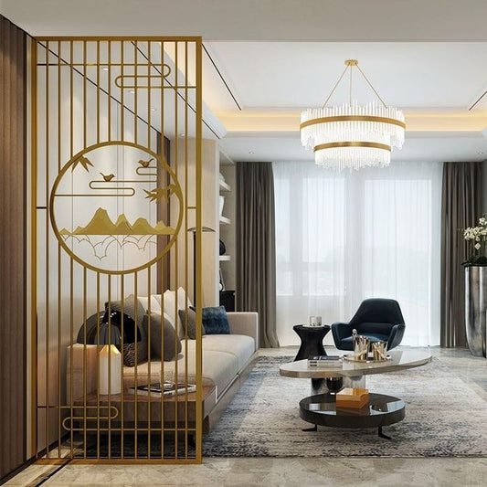 A gold metal partition with an artistic mountain and bird design in a modern living room featuring a chandelier, stylish furniture, and a neutral color palette.