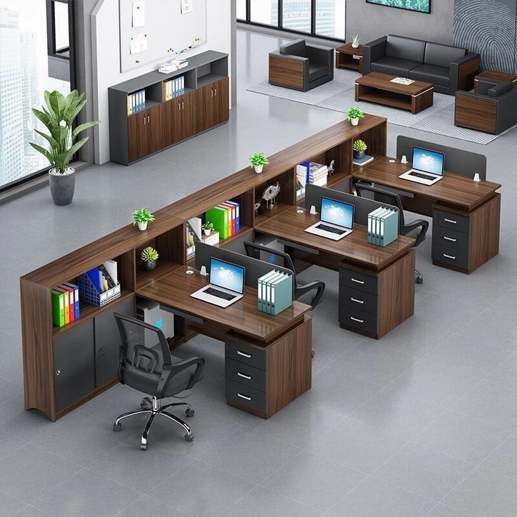Modern office workstation with wooden desks, storage cabinets, and ergonomic chairs