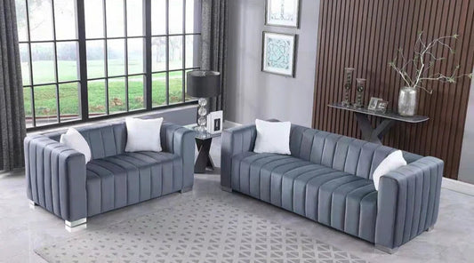 grey velvet 2-piece sofa set with tufted design, placed in a stylish living room with decorative pillows."