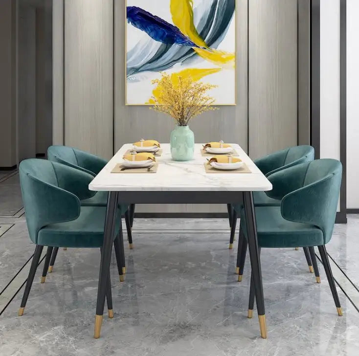 Elegant marble dining table with four velvet chairs, featuring a modern design with gold accents, perfect for homes and restaurants