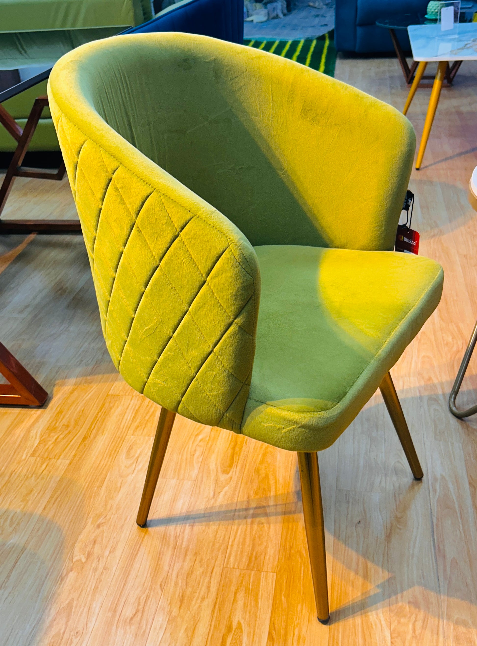 Mustard green velvet quilted dining chair with metal legs by BinSha Furniture.