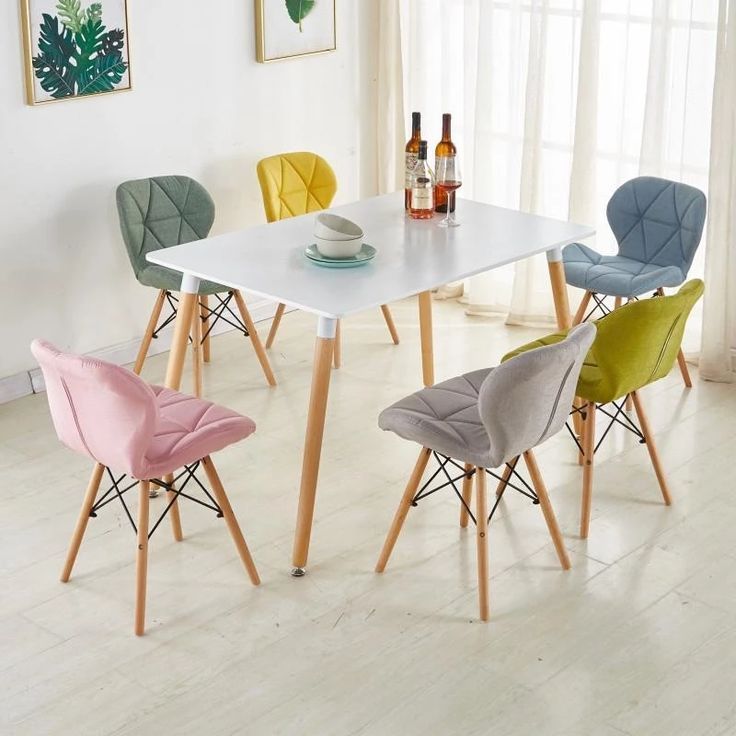 Colorful dining chair set with a white table, featuring modern design and sturdy wooden legs.