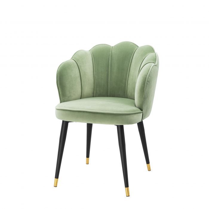 Sage green scalloped velvet chair with gold-tipped black legs, perfect for elegant dining or accent seating.